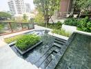 Rooftop terrace with a small garden and water feature