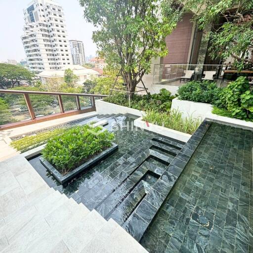 Rooftop terrace with a small garden and water feature