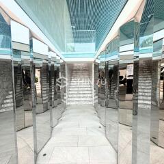 Modern building interior with mirrored walls and white marble flooring