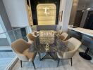 Modern dining area with a marble table and cushioned chairs