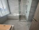 Modern bathroom with bathtub and glass shower enclosure