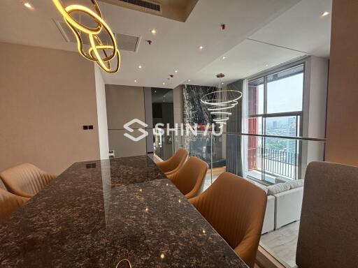 Modern living and dining area with city view