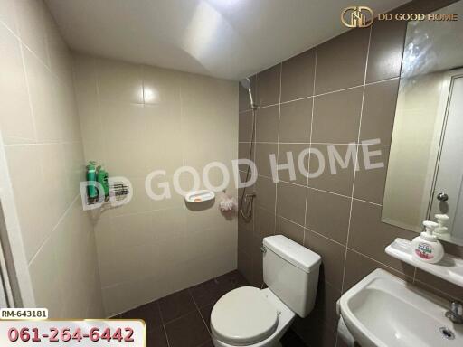 Modern bathroom with beige tiles and white fixtures