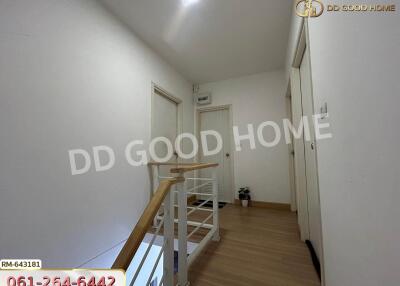 Upstairs hallway with multiple white doors and wooden floor