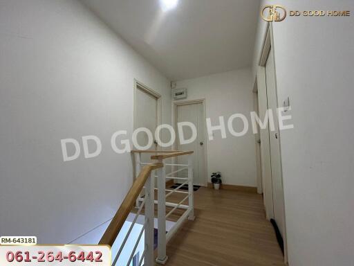 Upstairs hallway with multiple white doors and wooden floor