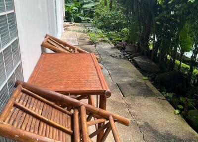 Outdoor seating area next to a garden