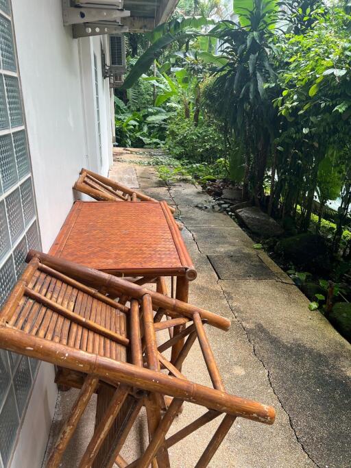 Outdoor seating area next to a garden