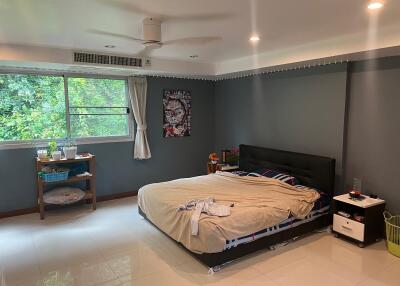 Spacious bedroom with a large window and modern decor