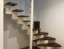 Interior staircase with wooden steps and metal railings