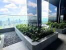 High-rise balcony with plants and city view