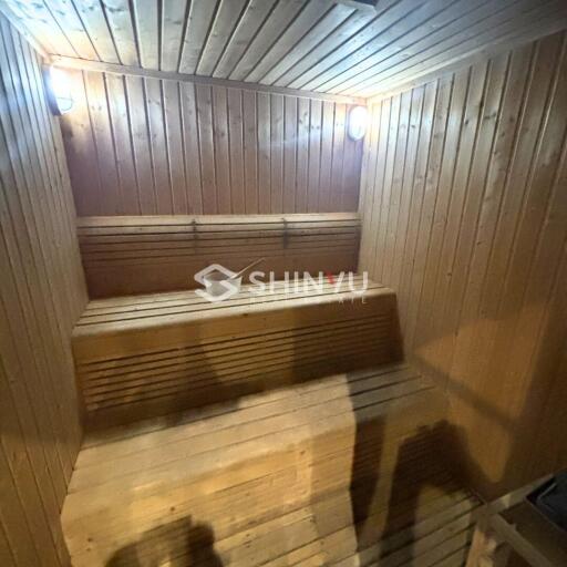 Well-lit wooden sauna with benches