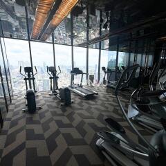 Modern high-rise building gym with city view