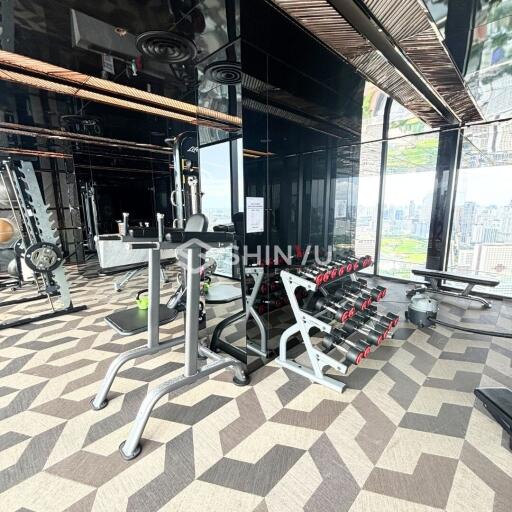 Modern fitness center with gym equipment and city view