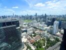 City skyline view with tall buildings and a green park area