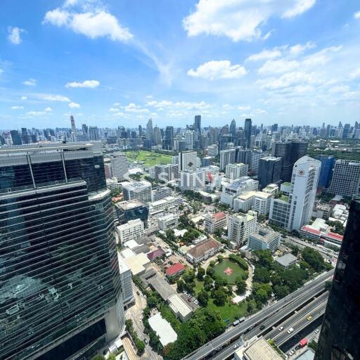 City skyline view with tall buildings and a green park area