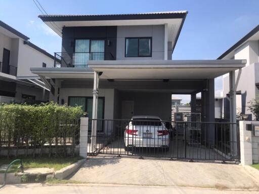 Modern double-story home with a carport