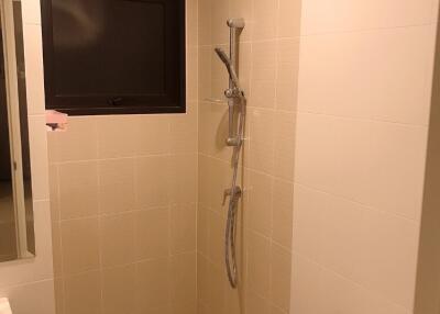 Bathroom with tiled walls and shower