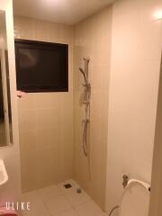 Bathroom with tiled walls and shower