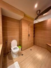 Modern bathroom with wood-style tiles and walk-in shower