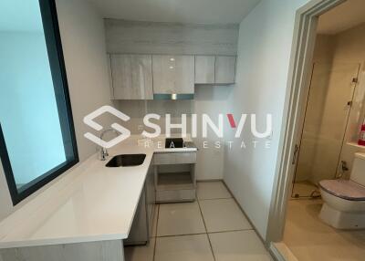 Modern kitchen area with sink, countertop, and cabinets