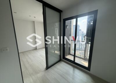 Bedroom with sliding glass doors and large windows