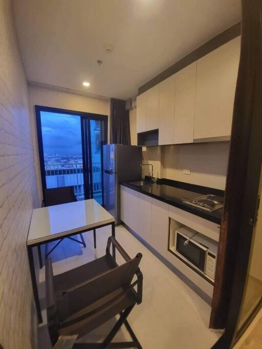 Modern kitchen with dining area and outdoor view