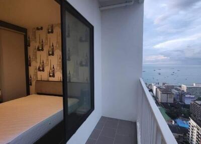 Balcony with a view of the city and adjacent bedroom