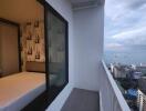 Balcony with a view of the city and adjacent bedroom