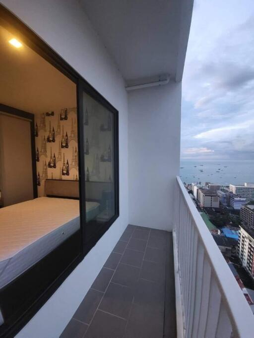 Balcony with a view of the city and adjacent bedroom