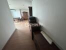 Hallway leading to dining area with wooden furniture