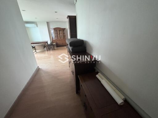 Hallway leading to dining area with wooden furniture