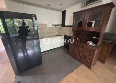 Modern kitchen with black fridge and built-in cabinets