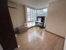 Bedroom with wooden flooring and a large window