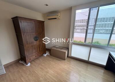 Bedroom with wooden wardrobe and large window