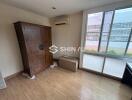 Bedroom with wooden wardrobe and large window