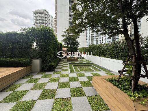 Outdoor communal garden with seating and greenery