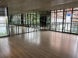 Dance studio with large windows and a mirrored wall