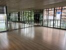 Dance studio with large windows and a mirrored wall