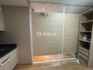 Partially furnished room with sliding doors