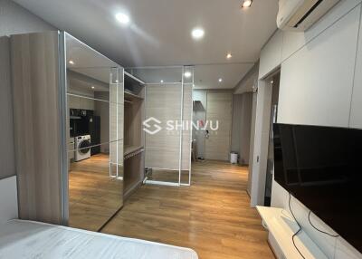 Modern bedroom with glass partitions and wooden flooring