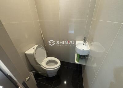 Small, modern bathroom with toilet and sink