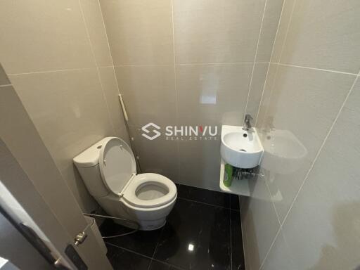 Small, modern bathroom with toilet and sink