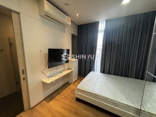 Modern bedroom with air conditioning and wall-mounted TV