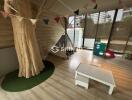 Children's playroom with a tree element, teepee tent, and toys