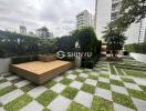 Modern outdoor recreational space with wooden deck and greenery at a residential building