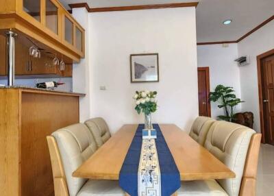 Cozy dining area with wooden furniture and kitchen view