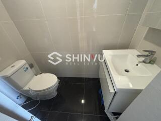 Small modern bathroom with toilet and sink