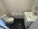 Small modern bathroom with toilet and sink