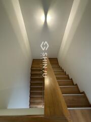 Staircase with wooden steps and bright lighting