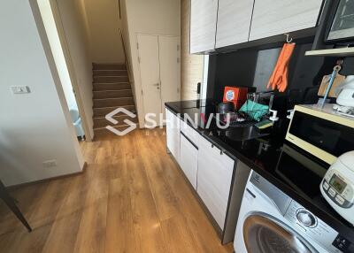 Modern kitchen with appliances and wooden flooring